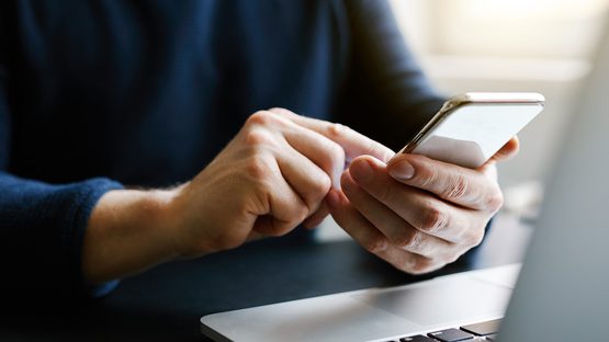 Man on phone with computer