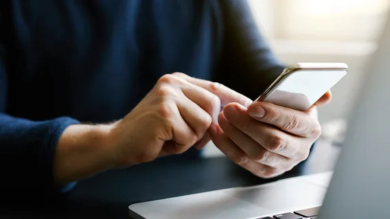 Man on phone with computer