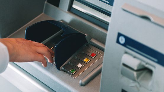 ATM skimming close up shot of pin entering