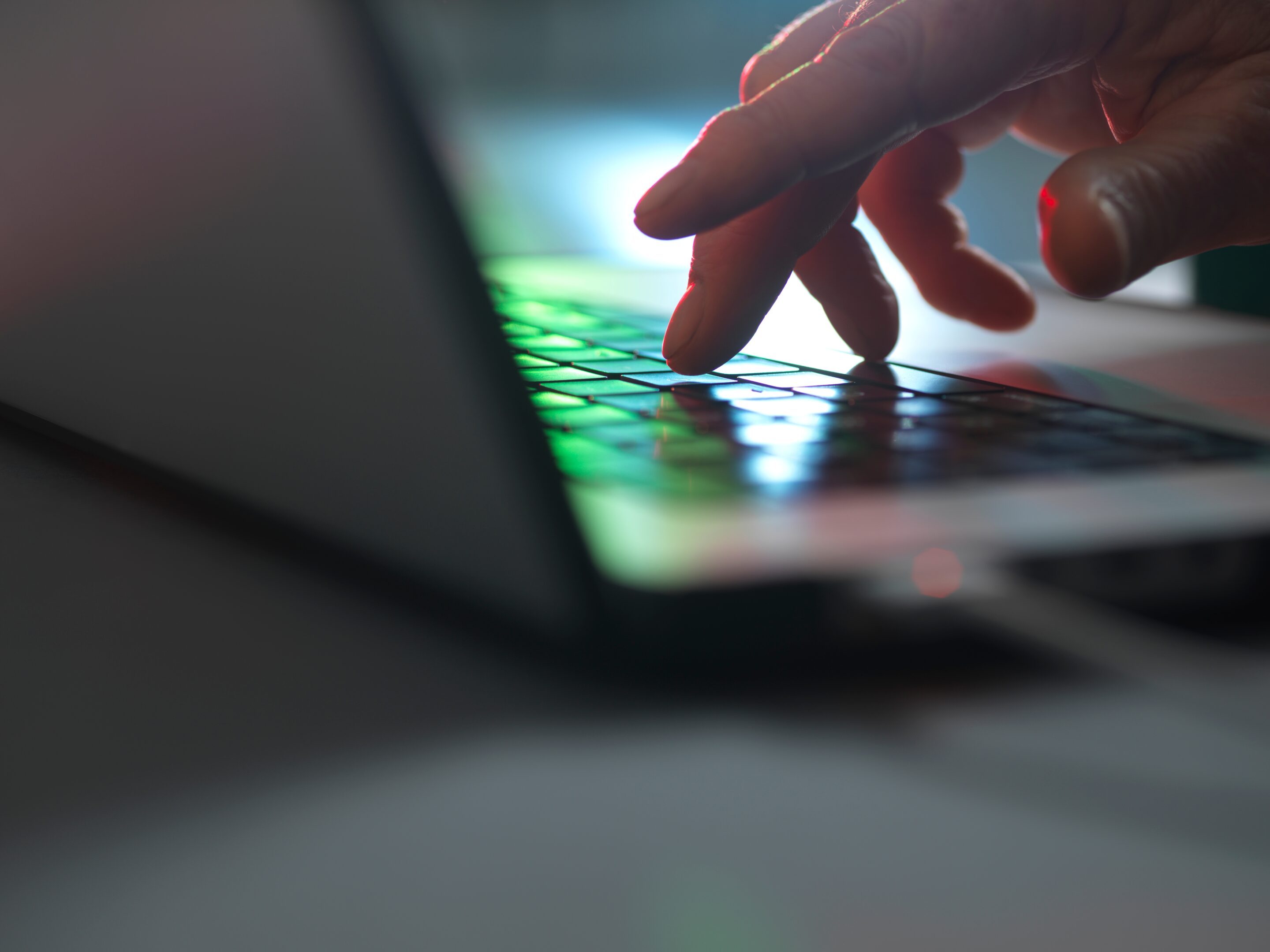 A person uses a laptop to set up AI-enabled financial crime controls.