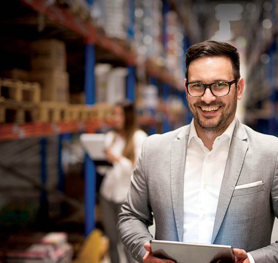man in suit standing in warehouse