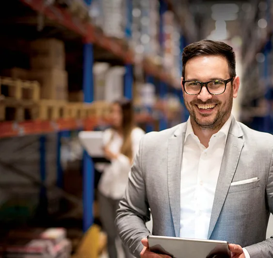 man in suit standing in warehouse