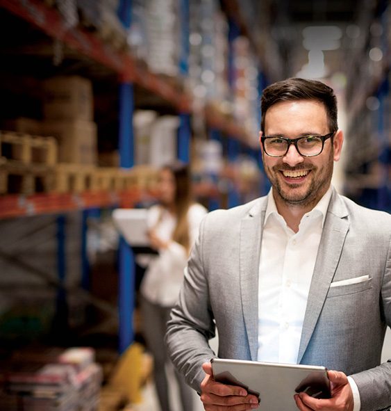 man in suit standing in warehouse