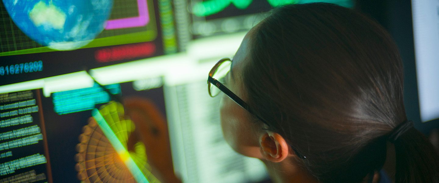 Image of woman looking at screens