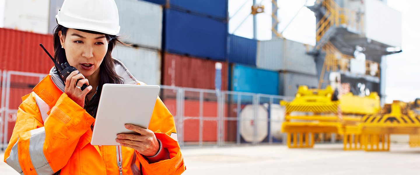 Construction worker in front of containers