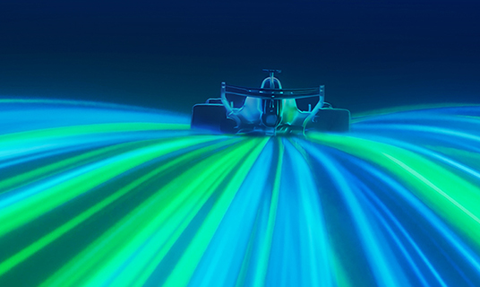 A car rides streaks of blue and green light.