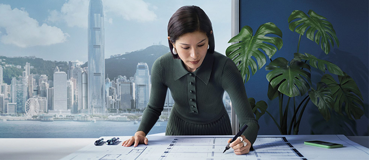 A woman sketches plans for her business.