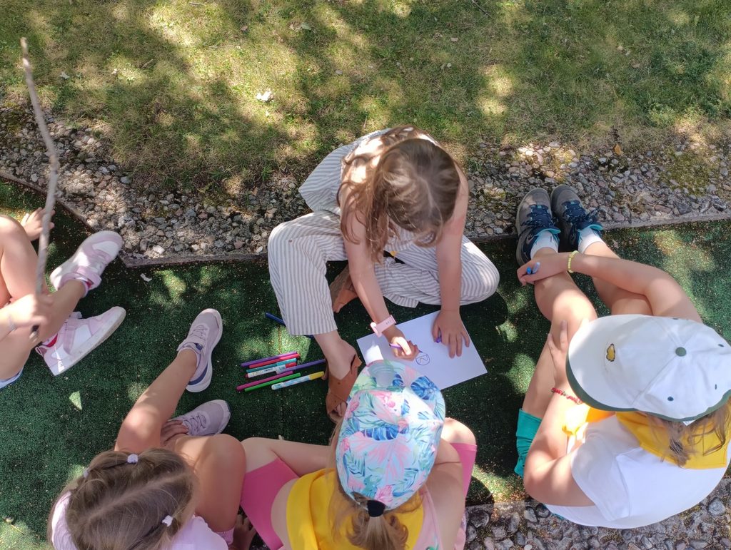 Children working on a coloured drawing