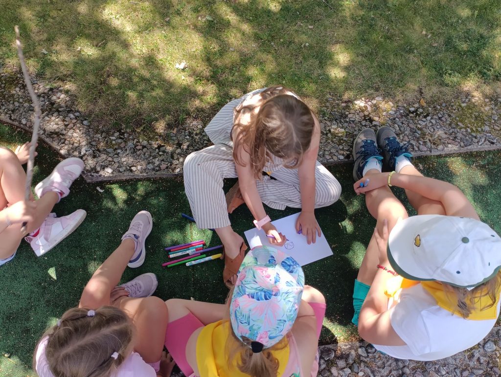 Children working on a coloured drawing